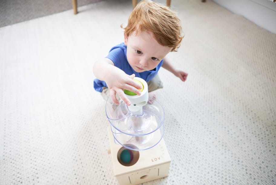 child playing with slide and seek ball run